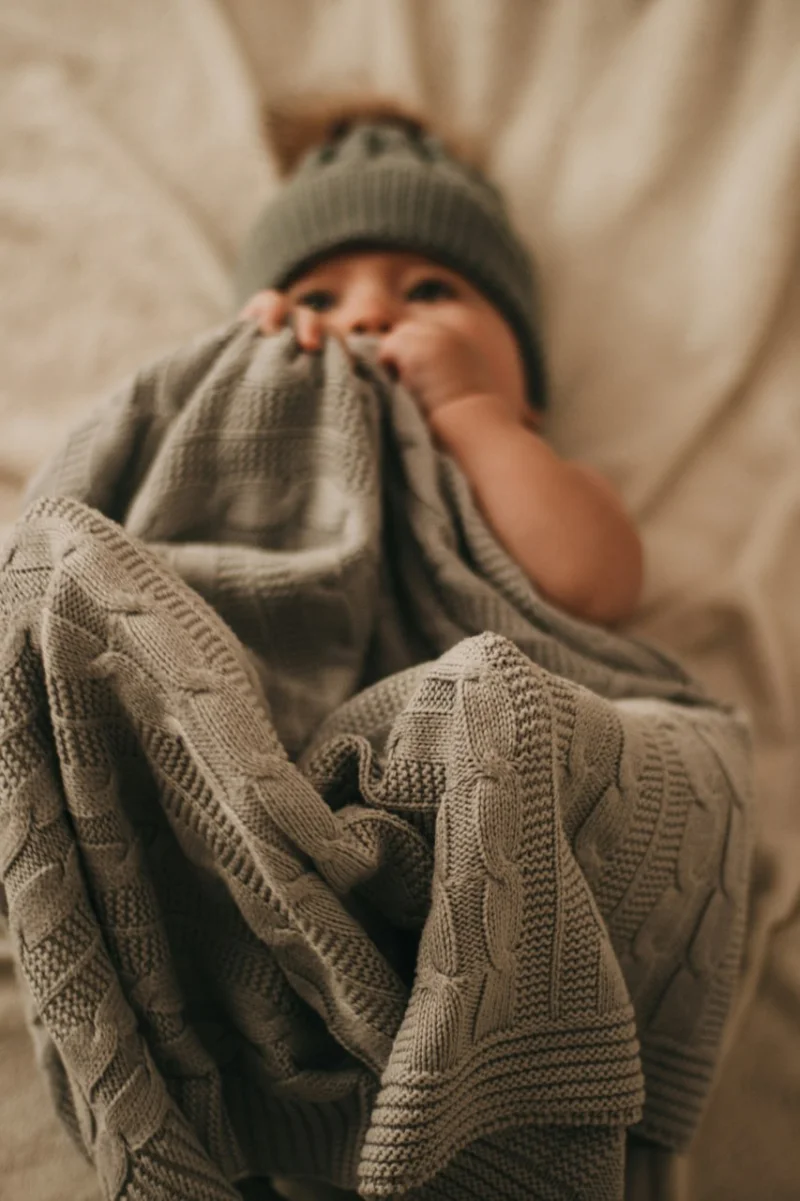 Baby sleeping safely in a sleep sack with arms free — safe sleep setup for Australian parents
